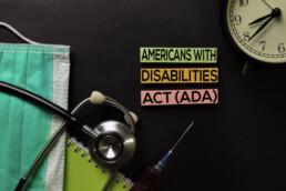 Americans with Disabilites Atc (ADA) text on top view black table with blood sample and Healthcare/medical concept.