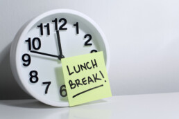 Lunch break note on office clock